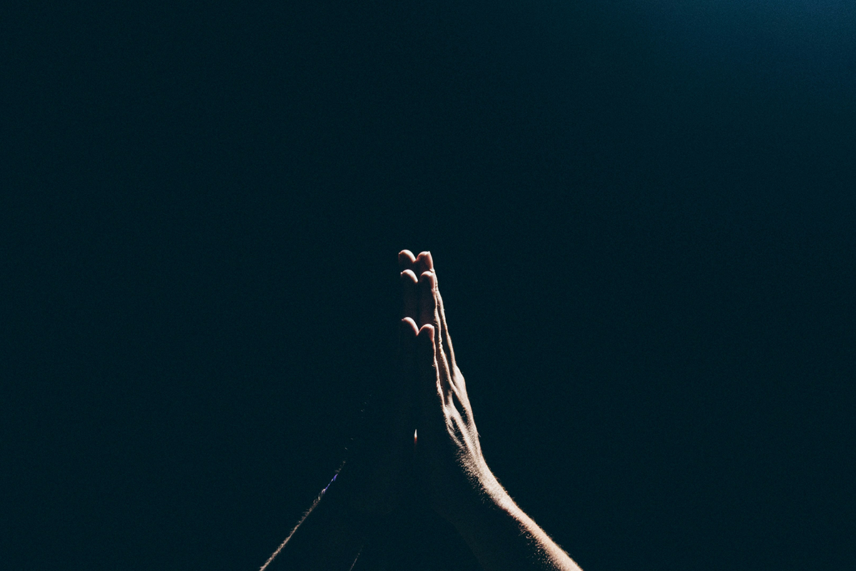 praying hands blue background
